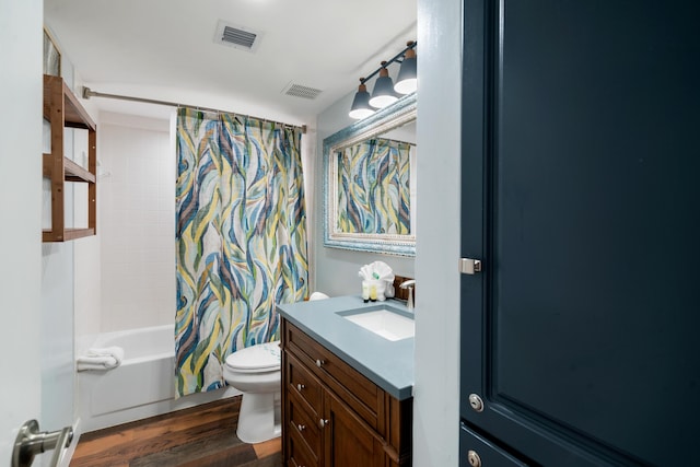 bathroom featuring visible vents, toilet, wood finished floors, shower / bath combination with curtain, and vanity