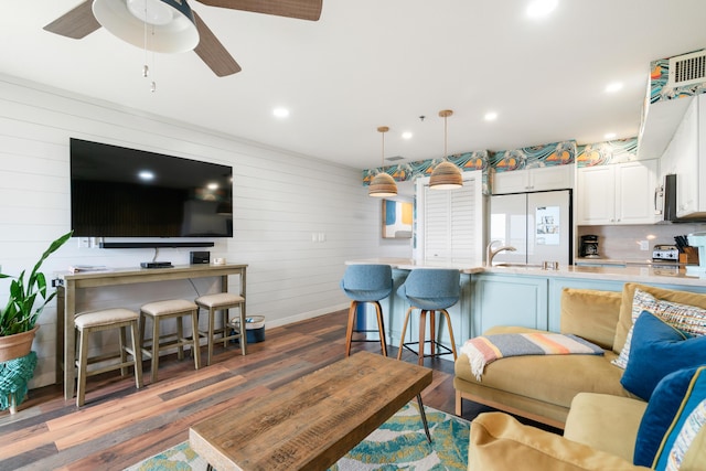 living room with a ceiling fan, baseboards, dark wood-type flooring, and recessed lighting