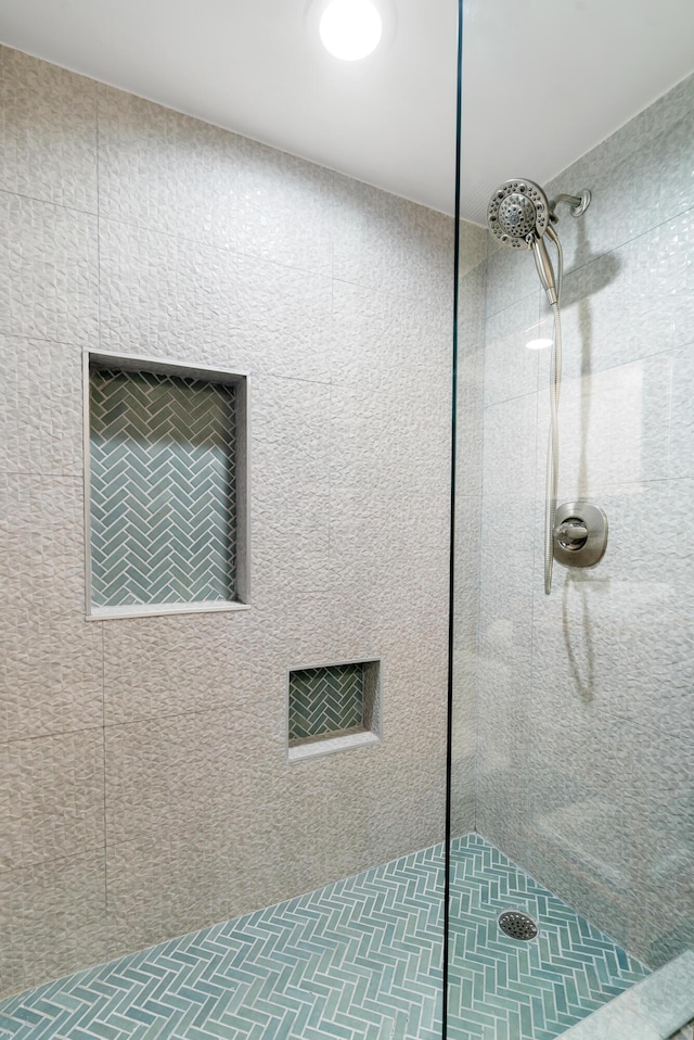 bathroom with tiled shower