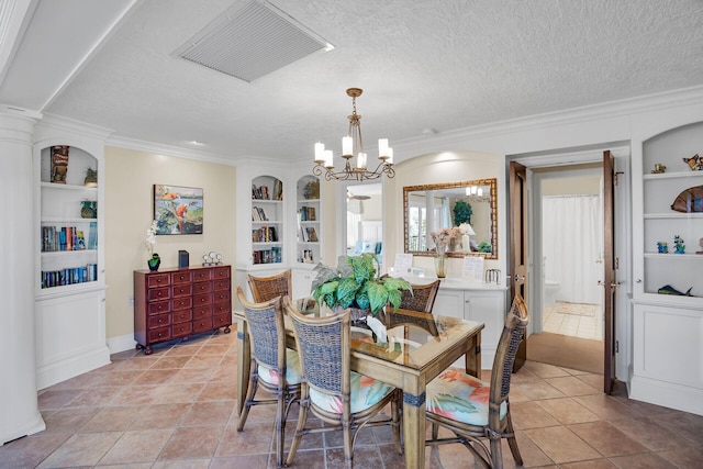 tiled dining area with crown molding, a chandelier, a textured ceiling, and built in shelves