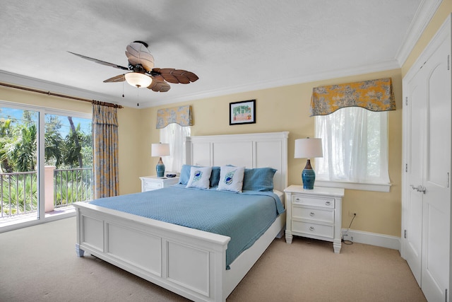 carpeted bedroom featuring crown molding, ceiling fan, and a textured ceiling