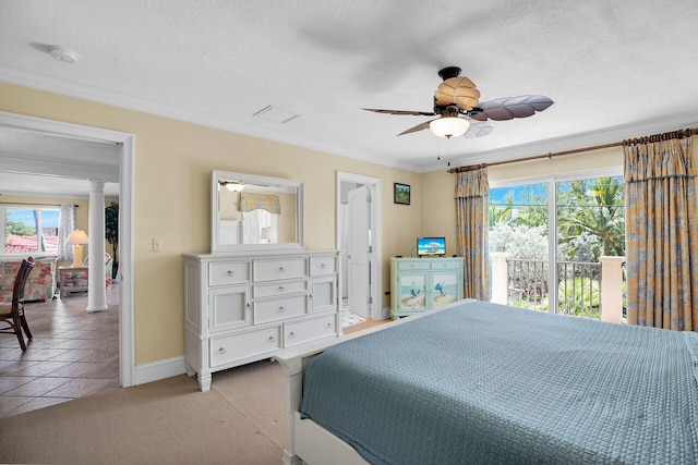 carpeted bedroom featuring crown molding, ceiling fan, decorative columns, and a textured ceiling