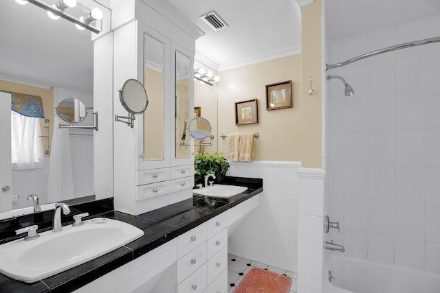 bathroom with crown molding, vanity, shower / bathtub combination with curtain, and tile walls