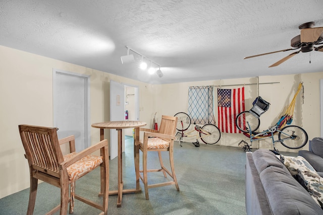 interior space featuring ceiling fan and a textured ceiling