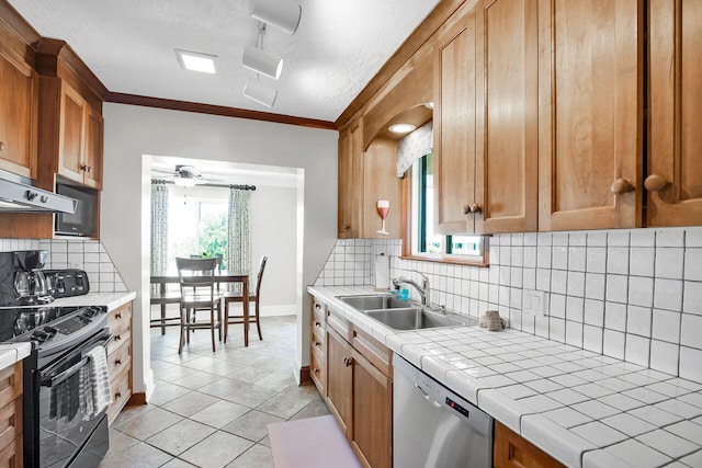 kitchen with sink, dishwasher, electric range, tile counters, and light tile patterned flooring