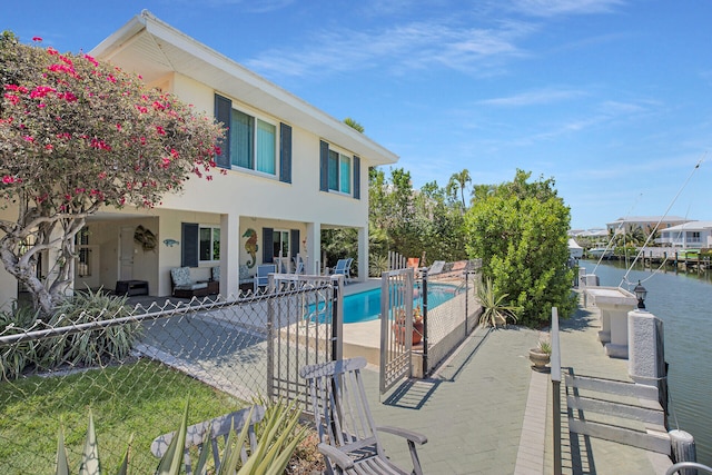 view of pool with a water view and a patio area