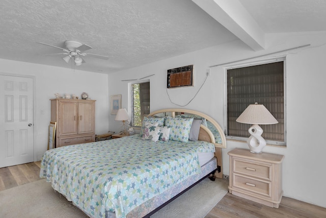585 116th St, Ocean, Marathon, FL 33050 - bedroom with a wall mounted air conditioner, wood finished floors, a textured ceiling, and ceiling fan