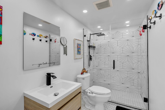 bathroom featuring tile patterned floors, vanity, toilet, and a shower with door