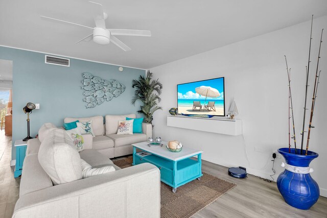 living room with ceiling fan and light hardwood / wood-style floors