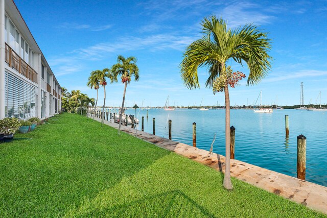 dock area featuring a lawn and a water view