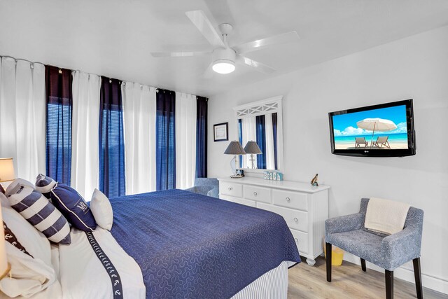 bedroom with light hardwood / wood-style flooring and ceiling fan