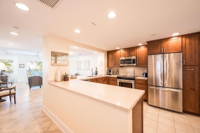 105 Front St Unit 121, Key West, FL 33040 - kitchen with recessed lighting, a peninsula, appliances with stainless steel finishes, and light tile patterned floors