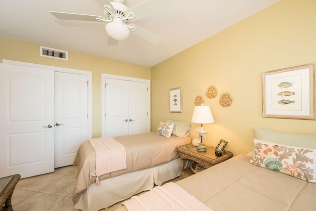 105 Front St Unit 121, Key West, FL 33040 - bedroom with multiple closets, ceiling fan, visible vents, and light tile patterned floors