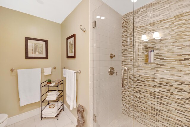 105 Front St Unit 121, Key West, FL 33040 - full bath featuring baseboards, tile patterned floors, a stall shower, and toilet
