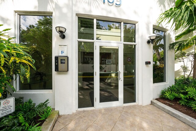 105 Front St Unit 121, Key West, FL 33040 - doorway to property with stucco siding