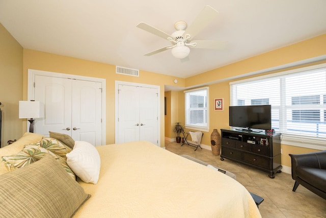 105 Front St Unit 121, Key West, FL 33040 - bedroom featuring visible vents, baseboards, multiple closets, and light tile patterned floors
