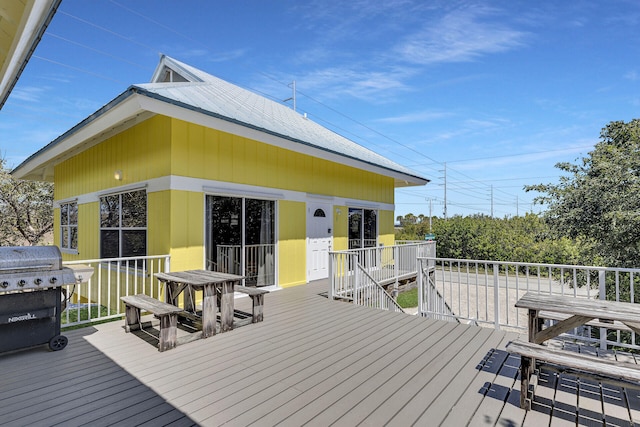 wooden deck with a grill