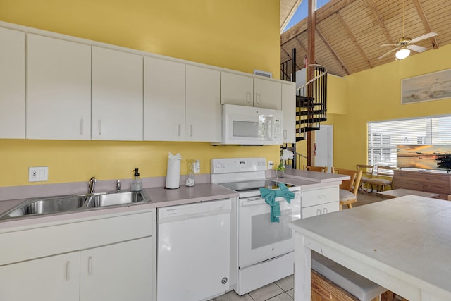 kitchen with white appliances, high vaulted ceiling, a sink, white cabinets, and wooden ceiling