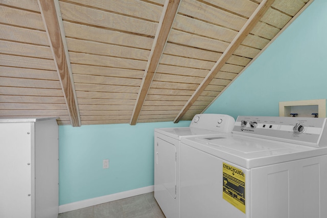 washroom with baseboards, laundry area, and washing machine and clothes dryer