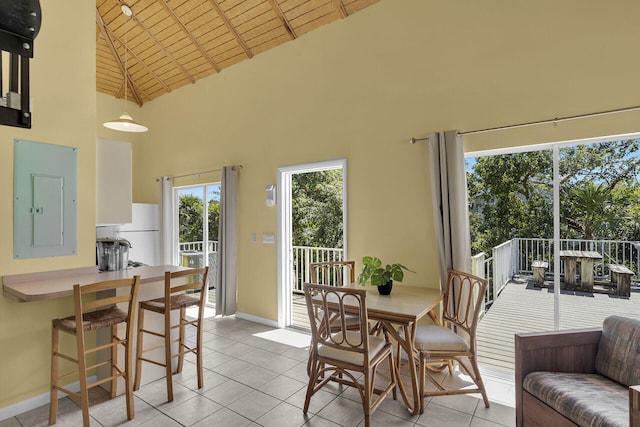 dining area with light tile patterned floors, baseboards, high vaulted ceiling, electric panel, and wooden ceiling