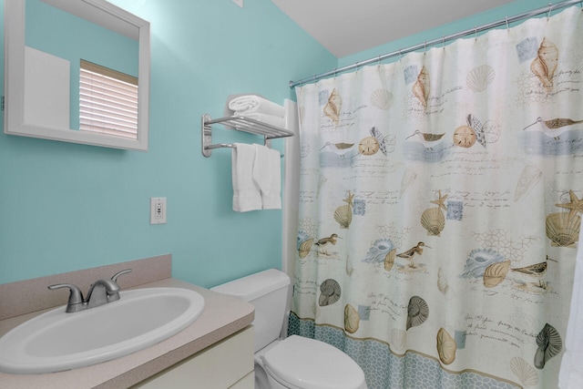 full bathroom with vanity, curtained shower, and toilet