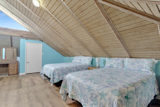 unfurnished bedroom featuring vaulted ceiling, wood ceiling, baseboards, and wood finished floors