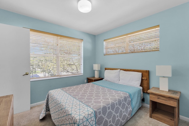 bedroom featuring baseboards and carpet flooring