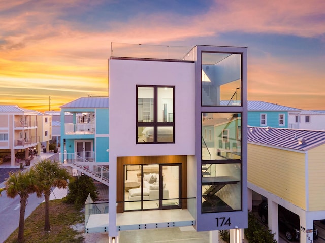 94825 Overseas Hwy Unit 174, Key Largo, FL 33037 - back of house with a balcony, a standing seam roof, metal roof, and stucco siding