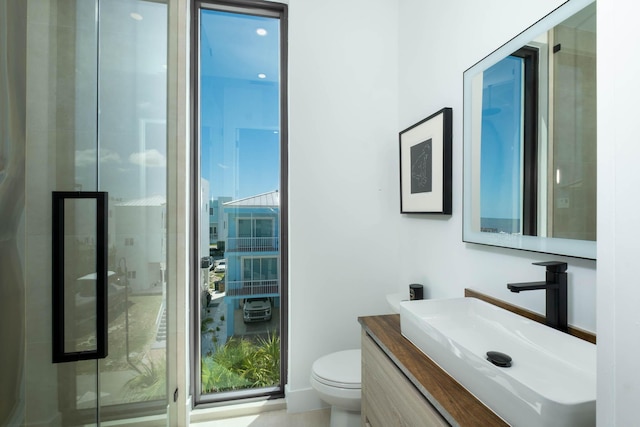 94825 Overseas Hwy Unit 174, Key Largo, FL 33037 - bathroom with toilet, plenty of natural light, vanity, and a shower stall