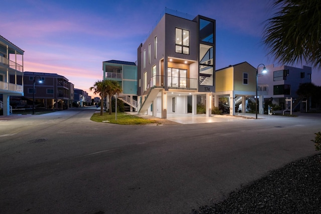 94825 Overseas Hwy Unit 174, Key Largo, FL 33037 - view of front of house with stucco siding, a carport, and stairs