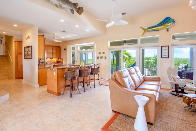 tiled living room featuring a high ceiling and ceiling fan