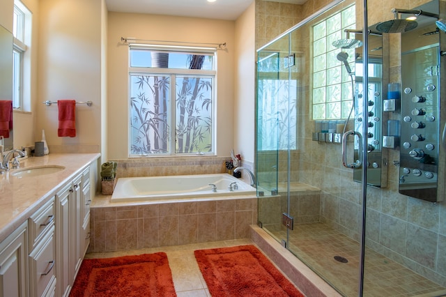 bathroom with shower with separate bathtub, vanity, and tile patterned floors