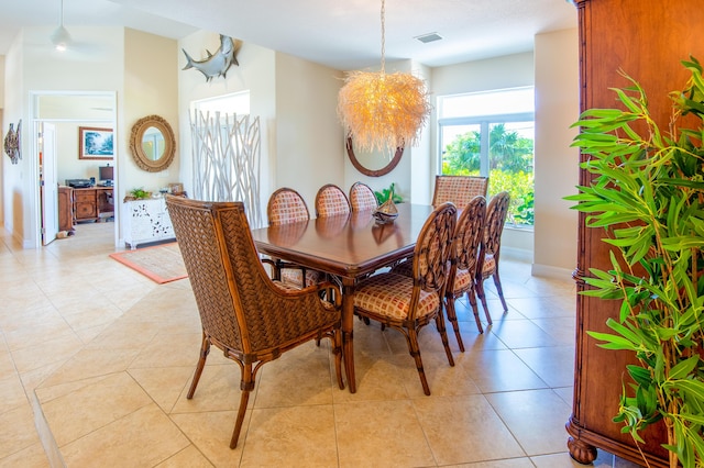 tiled dining space with an inviting chandelier