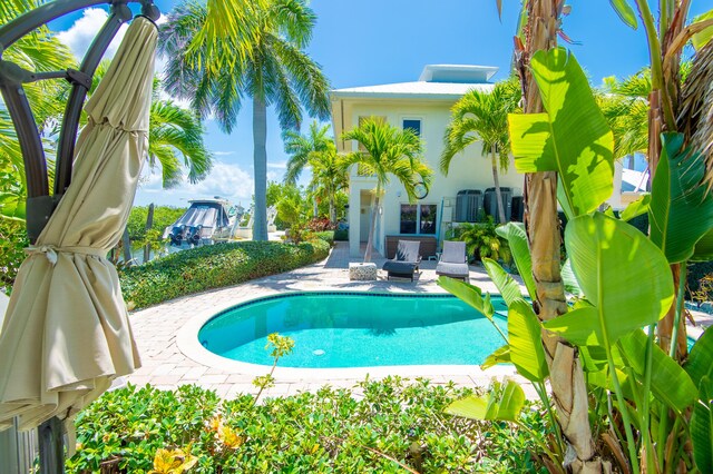 view of swimming pool with a patio area and a fire pit