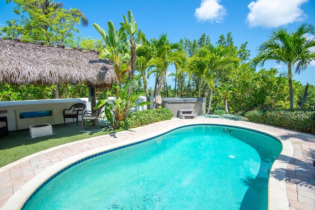 view of pool featuring a gazebo and a hot tub