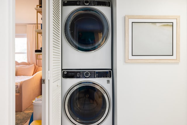 washroom featuring stacked washing maching and dryer