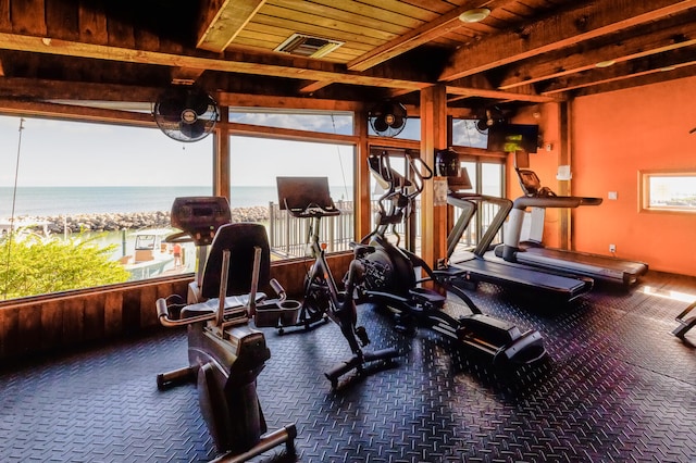 gym with a water view, wood ceiling, and a healthy amount of sunlight