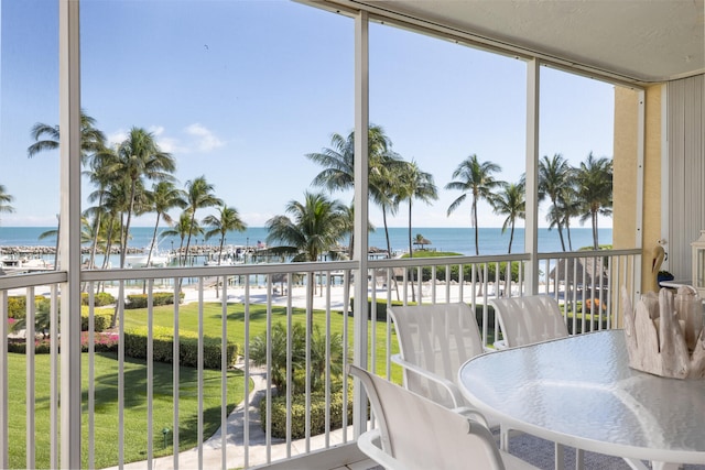 sunroom / solarium featuring a water view