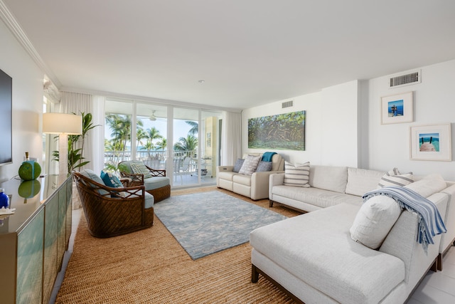 living room featuring expansive windows and crown molding