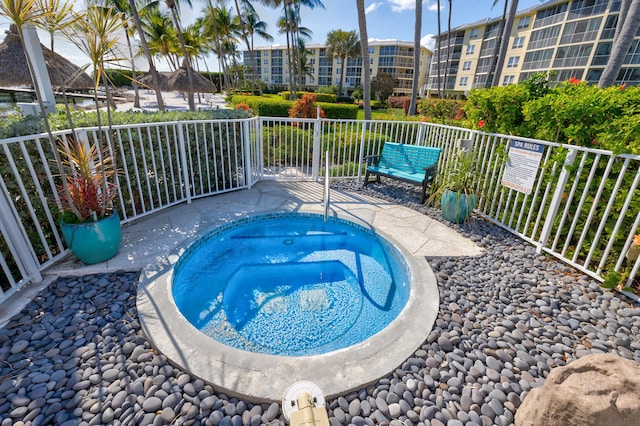 view of swimming pool featuring a community hot tub