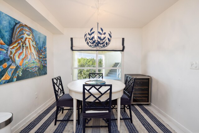 tiled dining area with wine cooler and an inviting chandelier