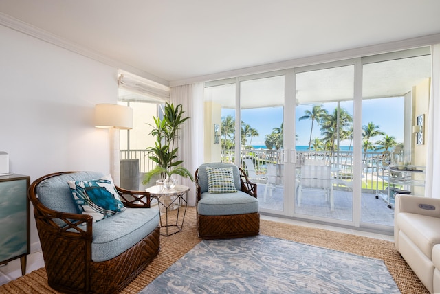 sitting room featuring a water view, floor to ceiling windows, and plenty of natural light