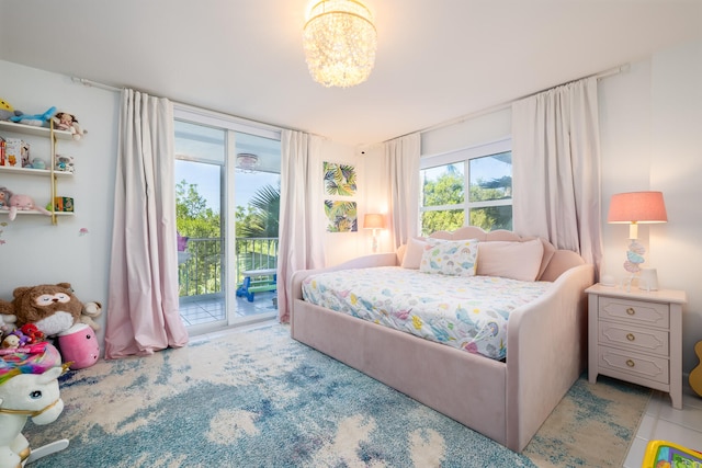 bedroom with access to outside and light tile patterned floors