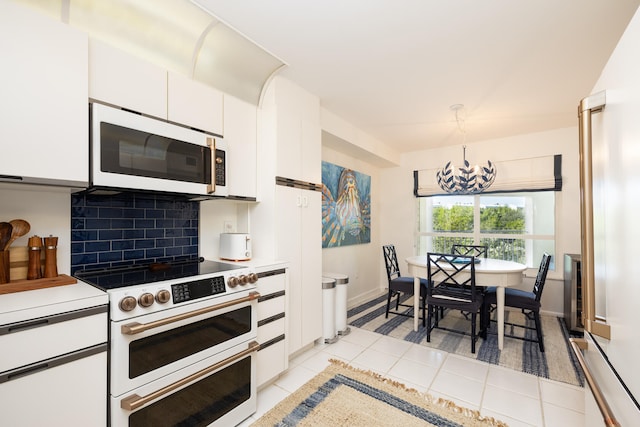 kitchen with hanging light fixtures, white cabinetry, backsplash, and white appliances