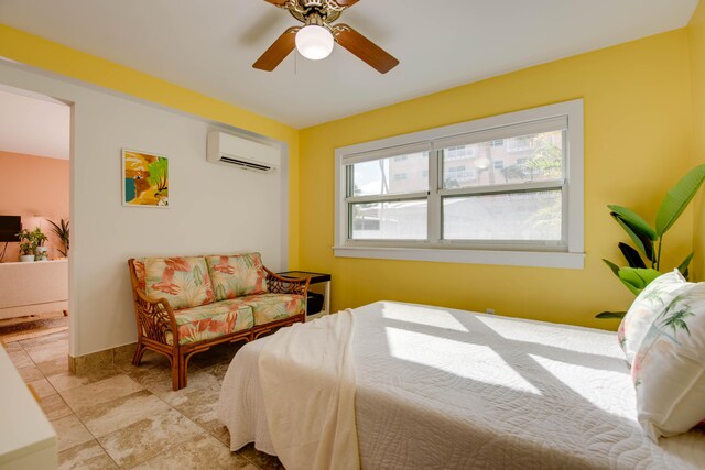 bedroom featuring a wall mounted air conditioner and ceiling fan