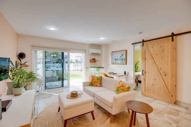 living room featuring a barn door, a wall mounted air conditioner, and light tile patterned floors