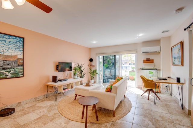 living room with light tile patterned floors, an AC wall unit, and ceiling fan