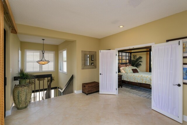 hall featuring light tile patterned flooring