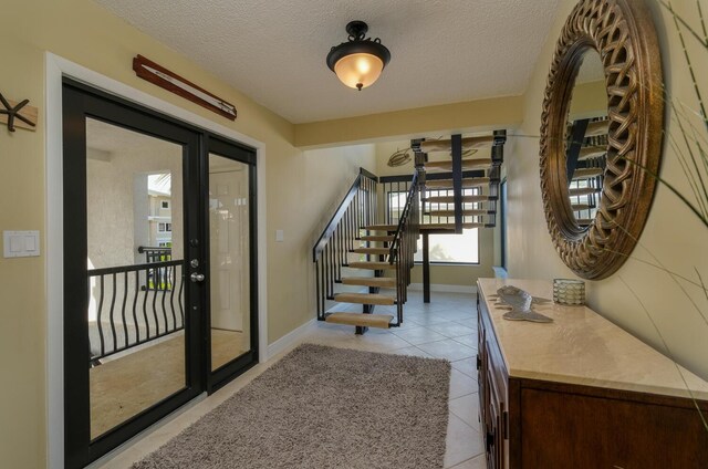 interior space featuring a textured ceiling and light tile patterned floors