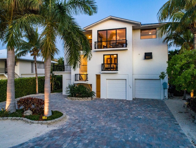 view of front of home featuring a garage and a balcony